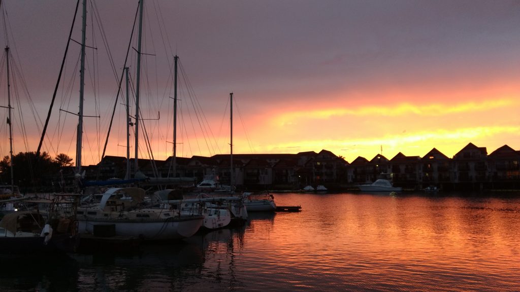 Marina with sailboats at sunset